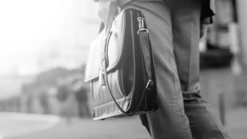 Businessperson holding a black briefcase.